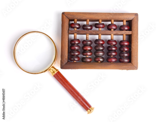 Chinese abacus and Magnifying glass,business concept photo