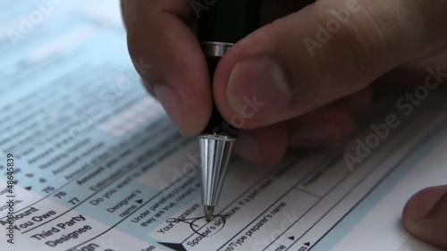 Signing a 1040 income tax return form