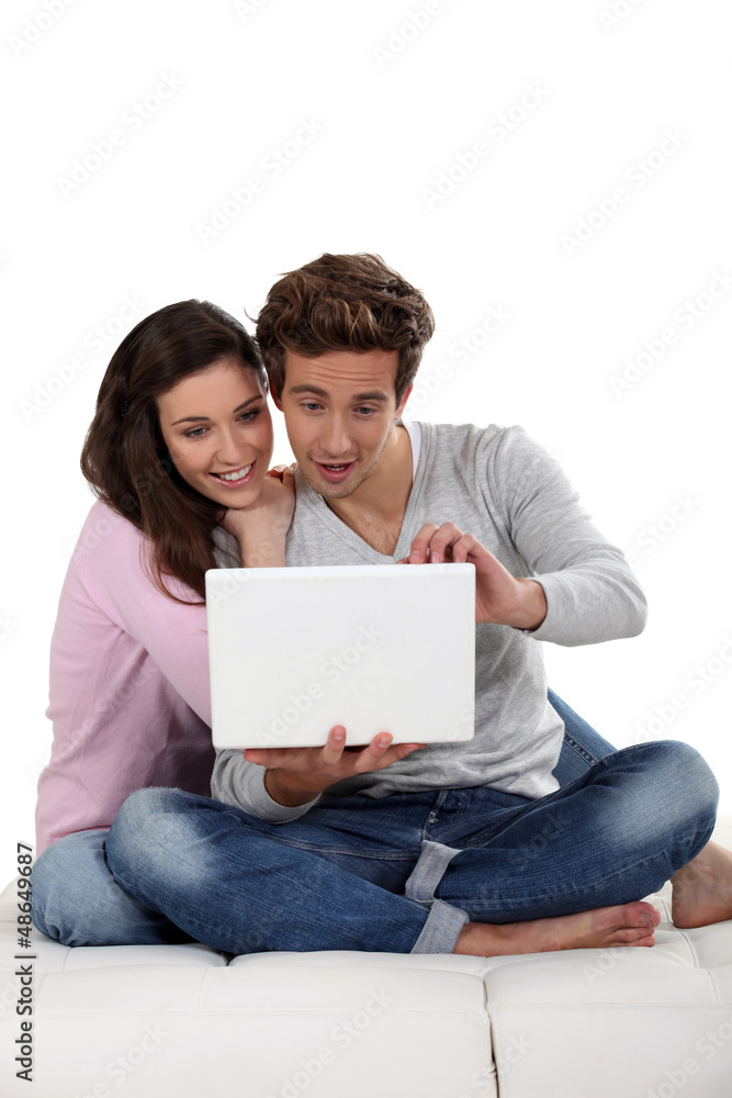 Young couple on sofa with laptop