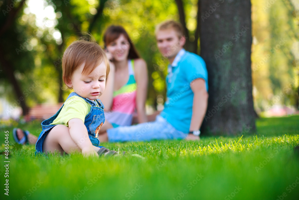 baby with parents in a beautiful summer park