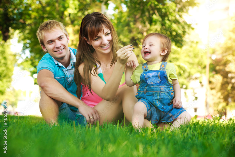 happy family on a green lawn in park happy family on a green lawn in park