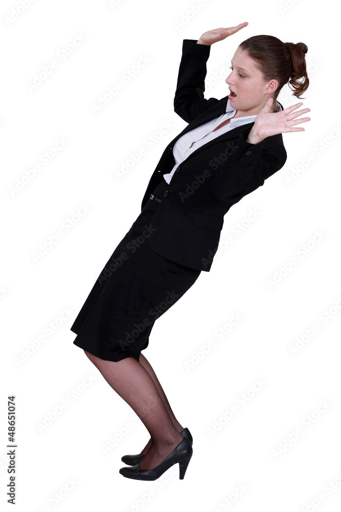 Businesswoman struggling to keep balance Businesswoman struggling to keep balance