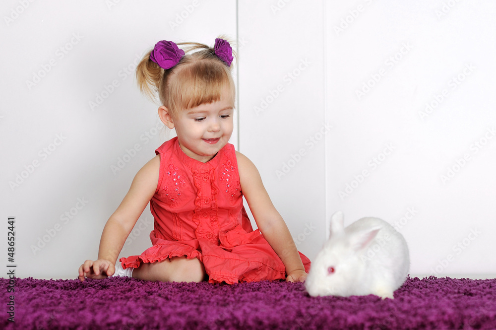 Smiling little girl and white rabbit Smiling little girl and white rabbit