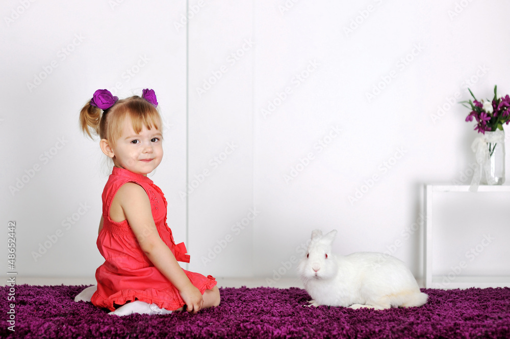 Smiling little girl and white rabbit Smiling little girl and white rabbit