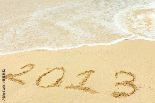 2013 written in sand on beach