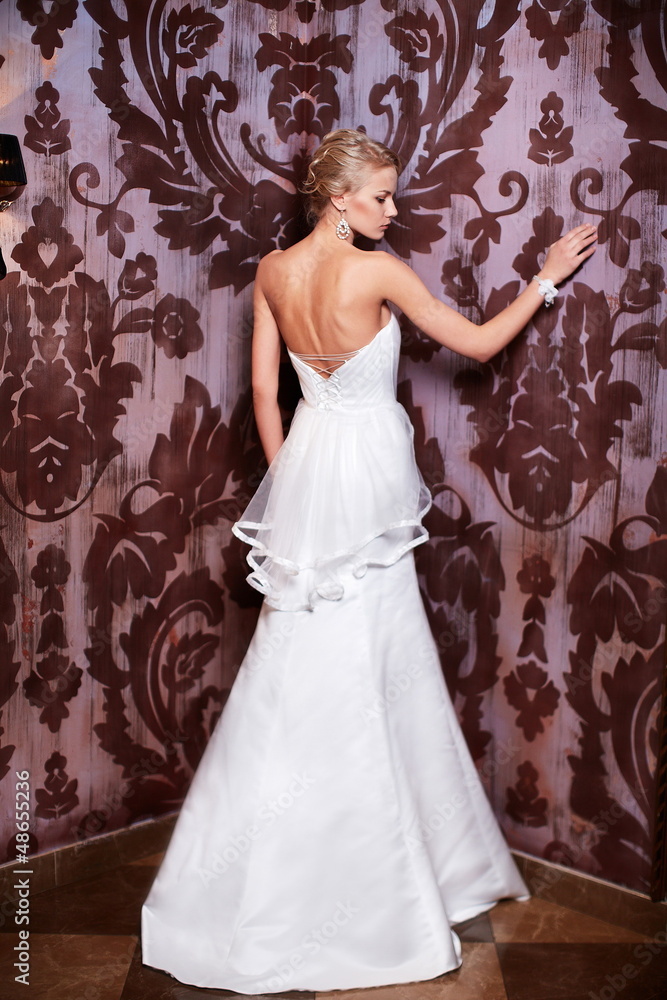sexy blond bride in white wedding dress in interior sexy blond bride in white wedding dress in interior