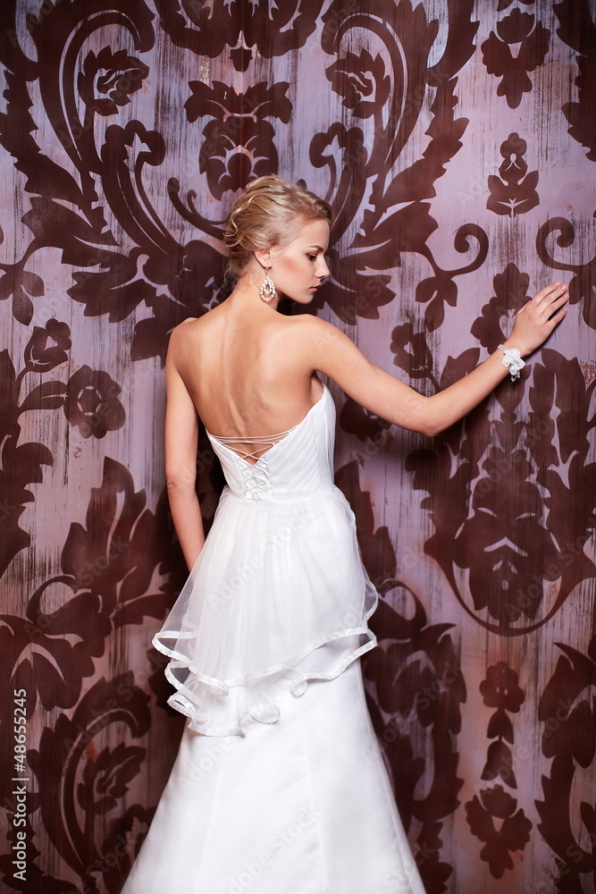 sexy blond bride in white wedding dress in interior sexy blond bride in white wedding dress in interior
