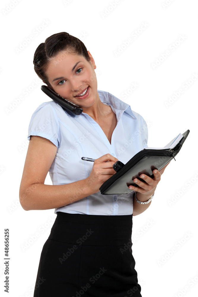 Businesswoman scheduling an appointment into her agenda Businesswoman scheduling an appointment into her agenda