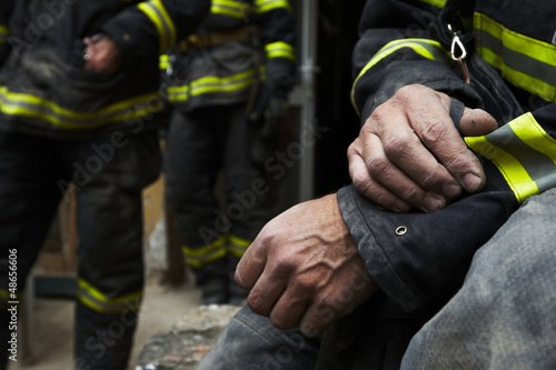 Canvas Print Sadness and hope. Firefighter resting during the rescue work.