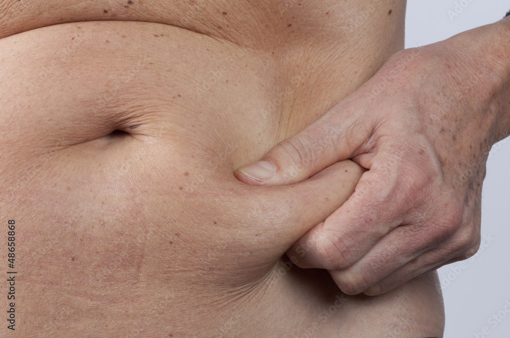 female person checking her belly fat female person checking her belly fat