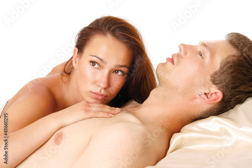A couple is lying in bed on white background