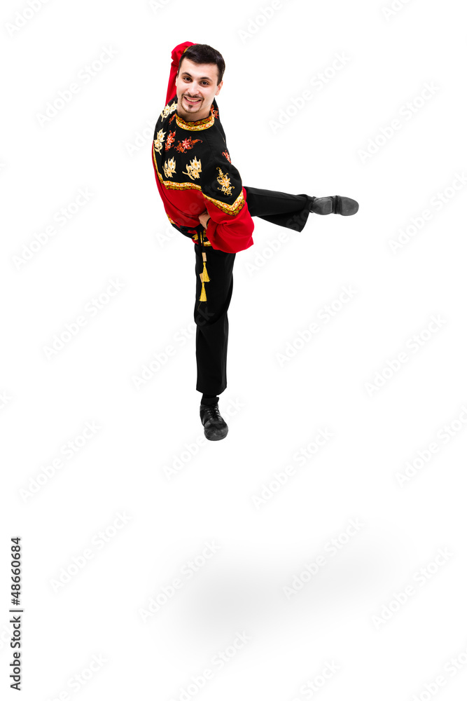 young dancer man wearing a folk russian costume jumping