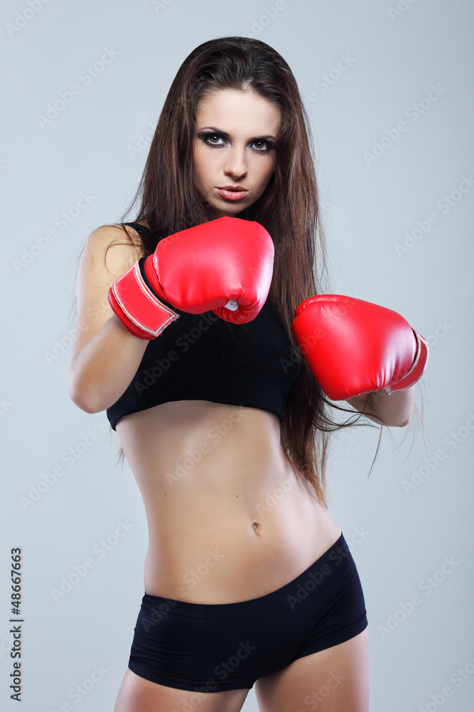 Beautiful sexual boxing girl, fitness, on a grey background Beautiful sexual boxing girl, fitness, on a grey background
