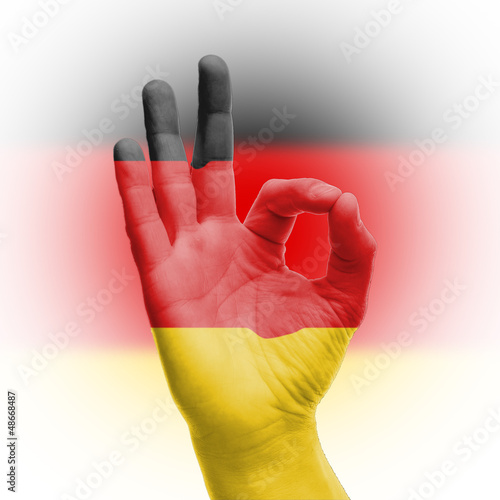 Obraz ręka OK znak z niemiecką flagą