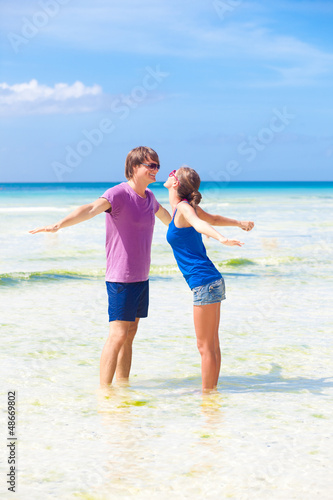 happy young couple having fun on the beach