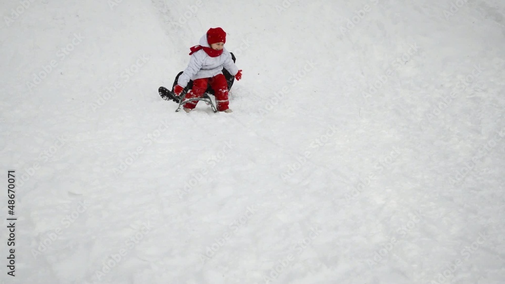 Family sledding, snow covered the hills, falling sledge Family sledding, snow covered the hills, falling sledge
