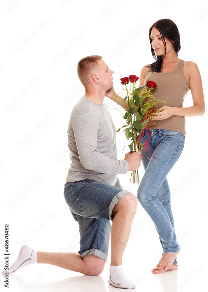 Attractive young couple gift rose in hand isolated Attractive young couple gift rose in hand isolated