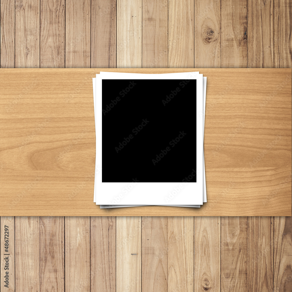 White blank Photo frame on wood texture background with space fo White blank Photo frame on wood texture background with space fo