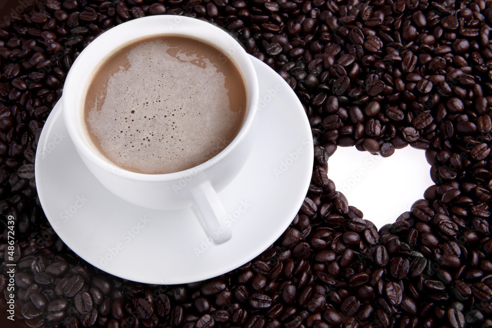 Fototapeta premium Coffee cup with beans and heart shape