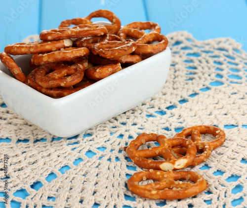 Tasty pretzels in white bowl and milk jug