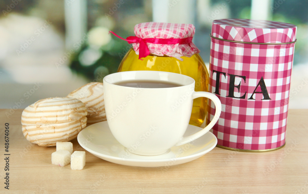Jar and cup of tea isolated on white Jar and cup of tea isolated on white