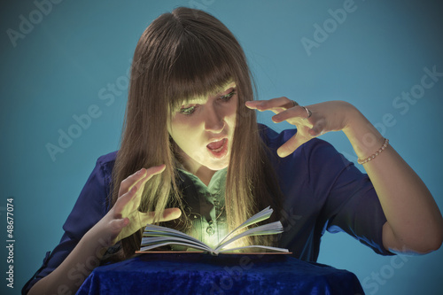 The girl conjures with the book