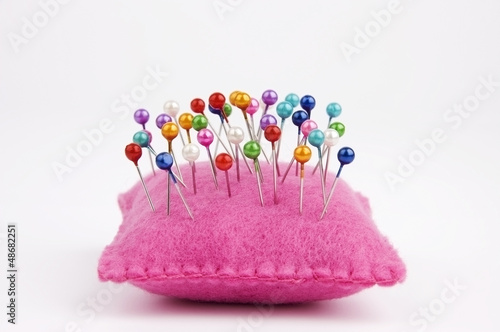 Canvas Print Handmade felt pin cushion with multicolored sewing pins stuck in