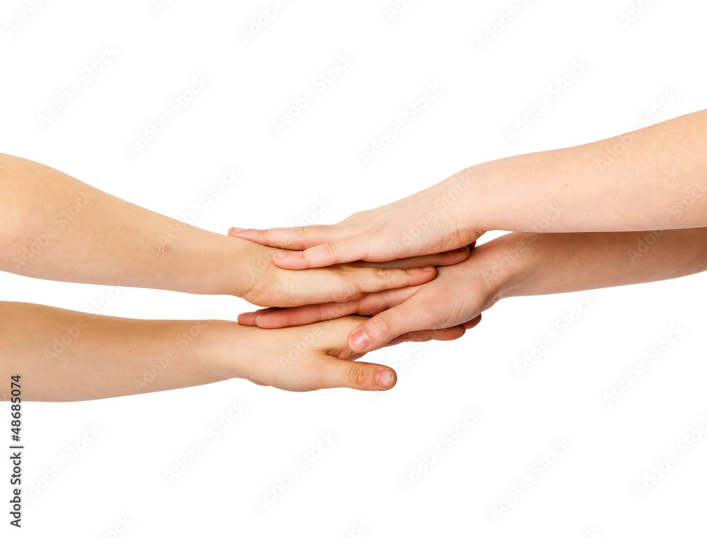 Two kids' hands lying on each other, isolated white Two kids' hands lying on each other, isolated white