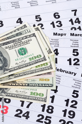 Banknotes of dollars on calendar sheets