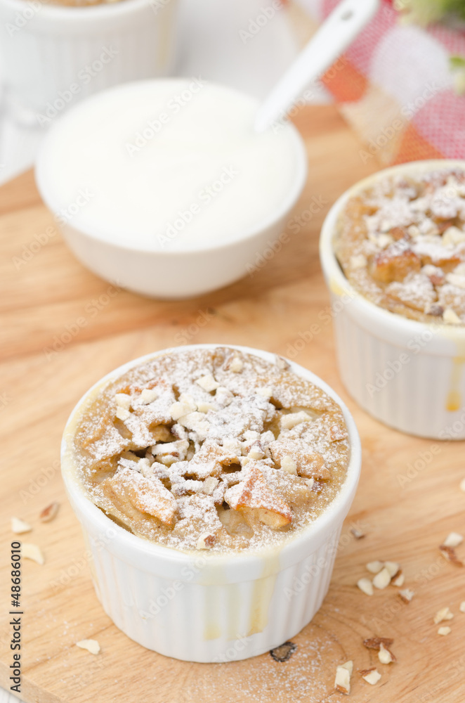 apple cake with nuts in a white ramekin top view apple cake with nuts in a white ramekin top view