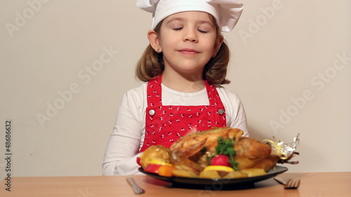 little girl cook with grilled chicken