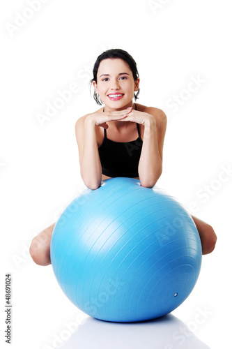 Beautiful young woman with pilates exercise ball.