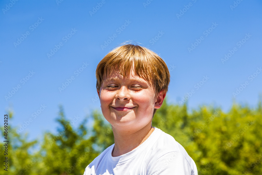 happy boy is smiling and closes eyes happy boy is smiling and closes eyes