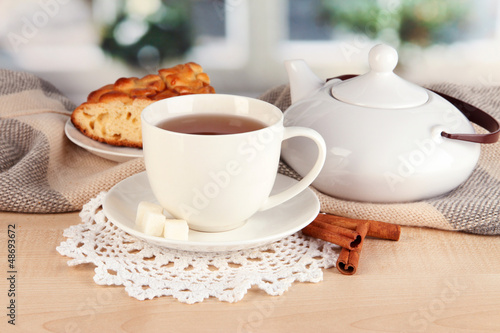 cup of tea with scarf on table in room