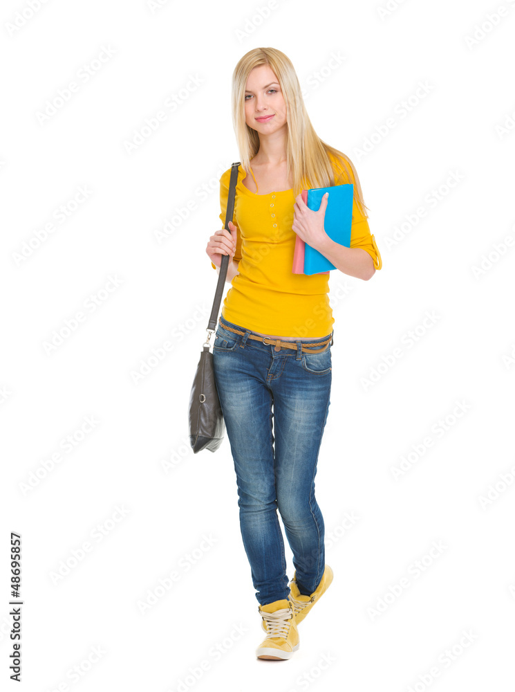 Teenage student girl with books going forward Teenage student girl with books going forward