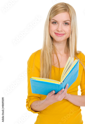 Portrait of smiling teenage student girl with book