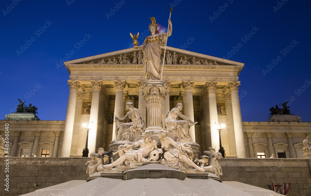 Fototapeta premium Vienna - Pallas Athena fountain and parliament in winter evening
