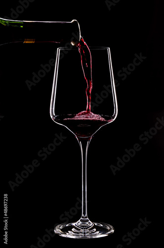 Red wine splashing in a glass.Close up