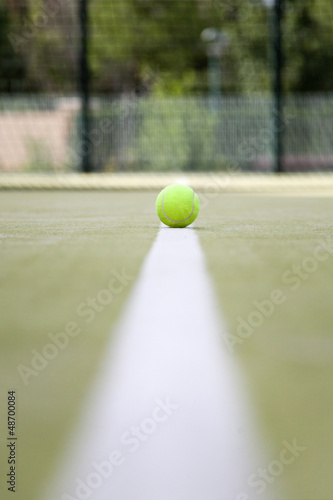 Yellow tennis ball on the white line