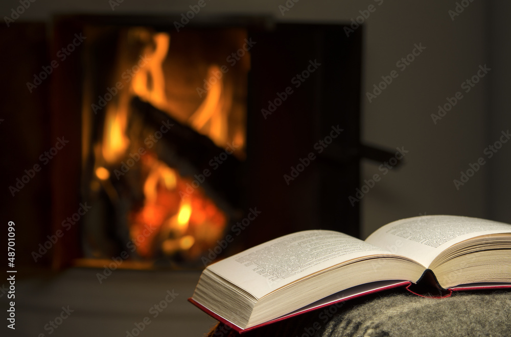 Peaceful and warm image of a open book by fireplace. Peaceful and warm image of a open book by fireplace.
