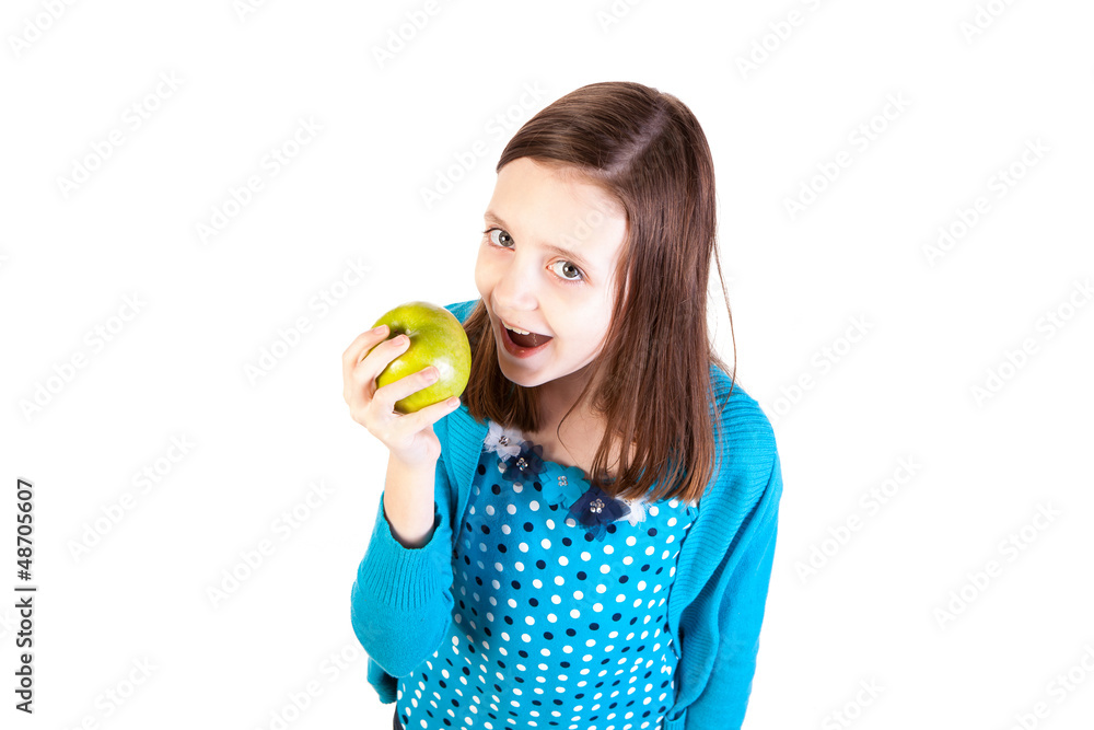 a young girl eating a delicious green apple