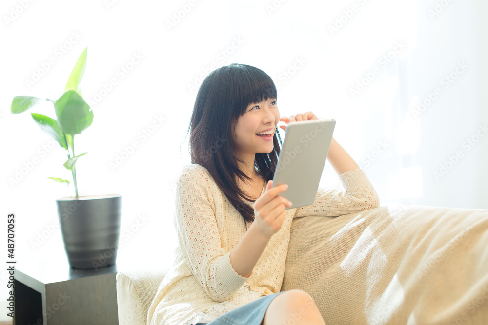 Beautiful asian woman using a tablet computer Beautiful asian woman using a tablet computer