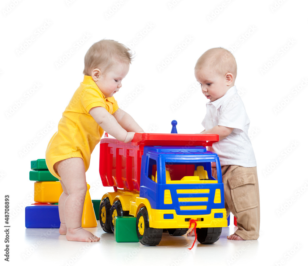 two little children playing with color toys two little children playing with color toys