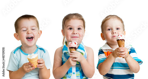 happy children boy and girls eating ice cream in studio isolated