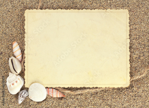 Old photo on the sand with shells
