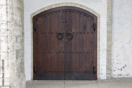Dark wooden door with antique metal handles