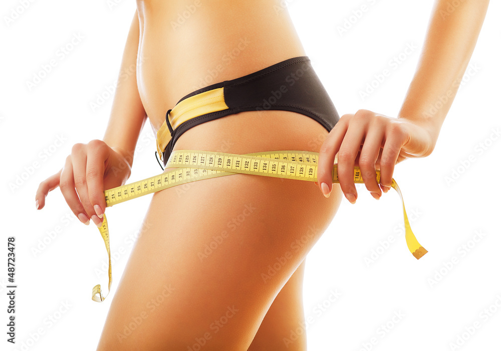 slimming woman measuring her body