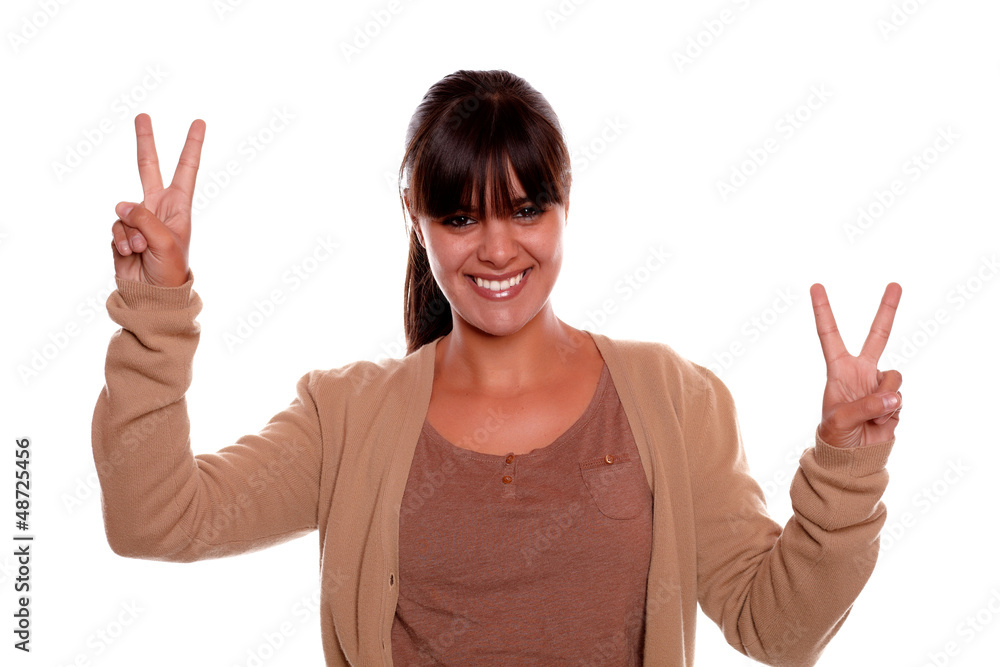 Young female smiling and showing you victory sign Young female smiling and showing you victory sign