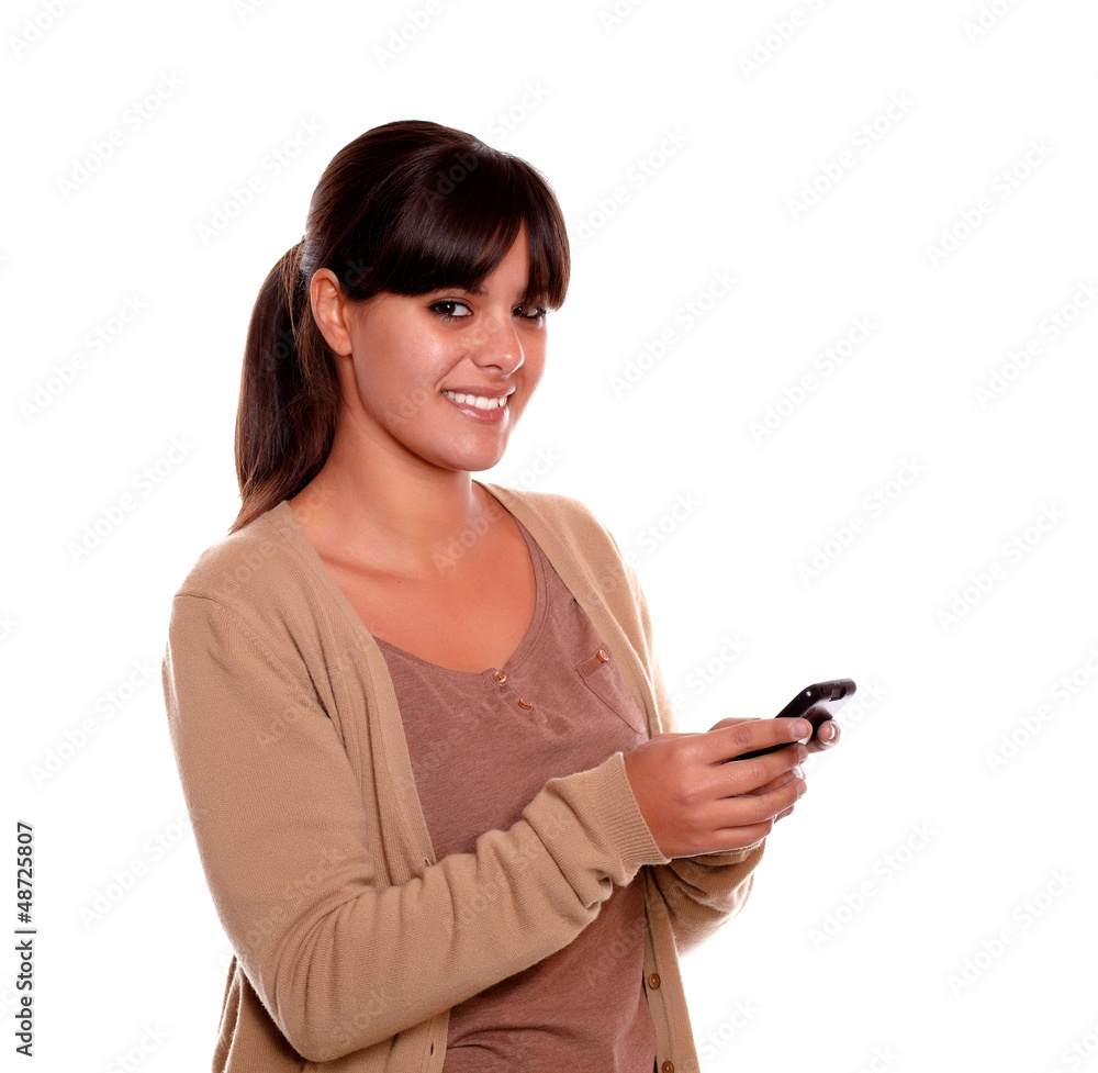 Charming young woman sending message by cellphone Charming young woman sending message by cellphone