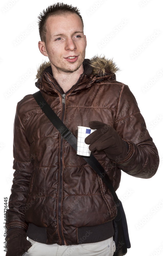 Young male holding disposable cup of hot drink in a warm coat Young male holding disposable cup of hot drink in a warm coat